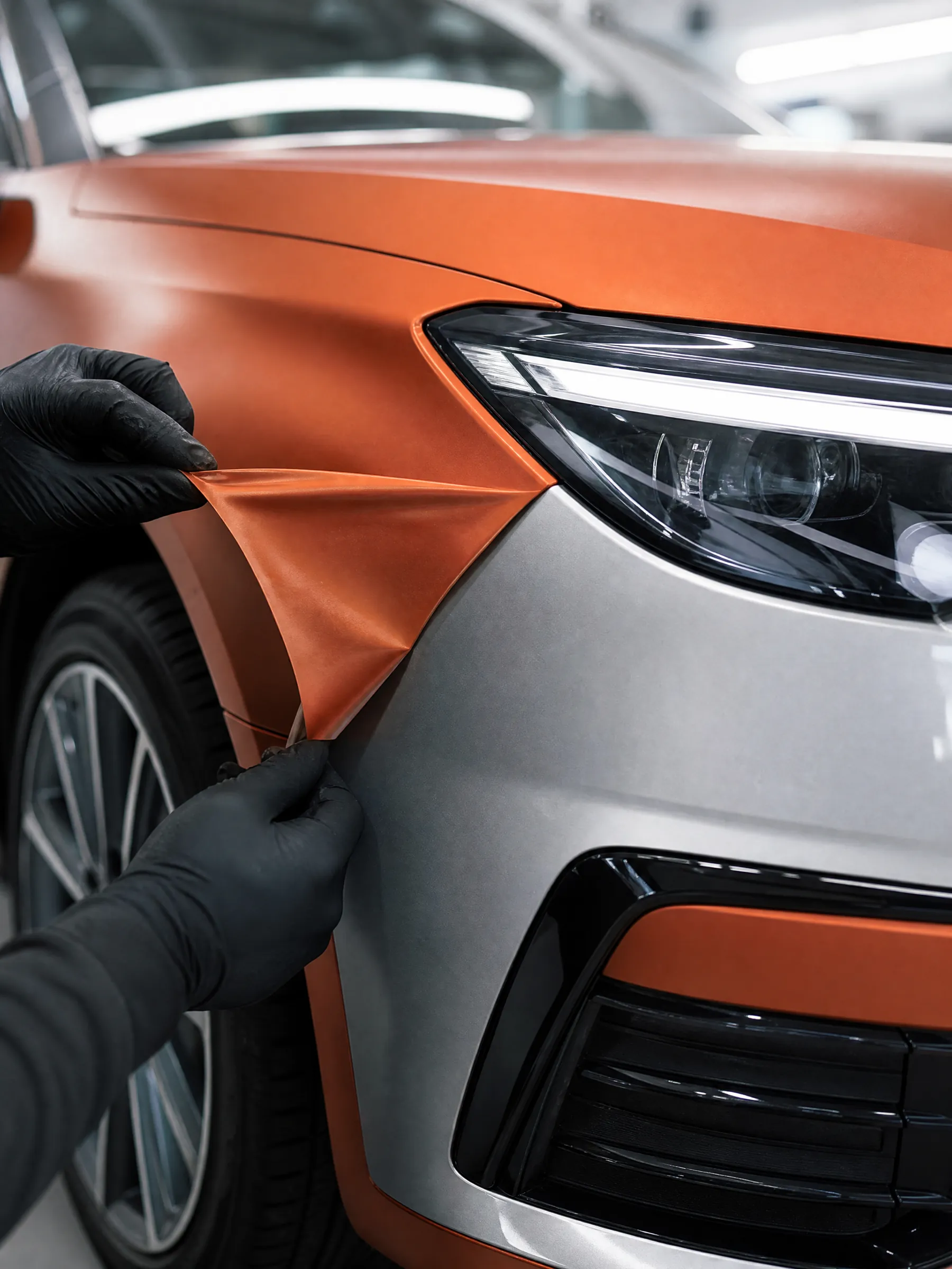 Orange film peeled back from a silver door
